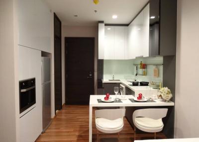 Modern kitchen with integrated appliances and dining area