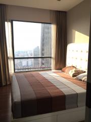 Bright bedroom with large window and city view