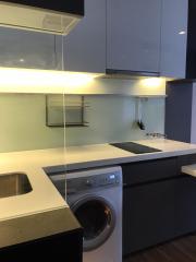 Modern kitchen with built-in appliances and light-colored countertops