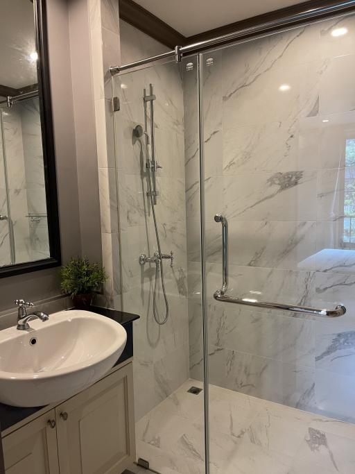 Modern bathroom with marble finish and glass shower