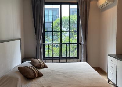 Cozy bedroom with natural light from a large window