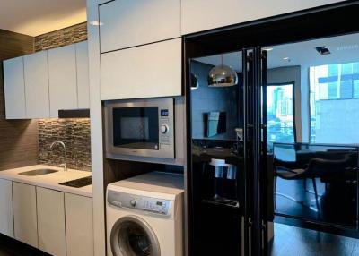 Modern kitchen with stainless steel appliances and stone backsplash