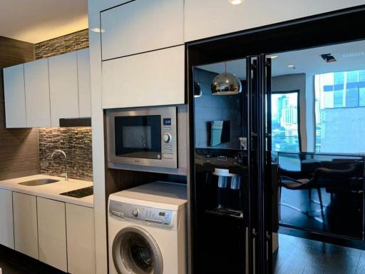 Modern kitchen with stainless steel appliances and stone backsplash