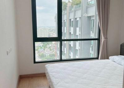 Spacious bedroom with large window and city view