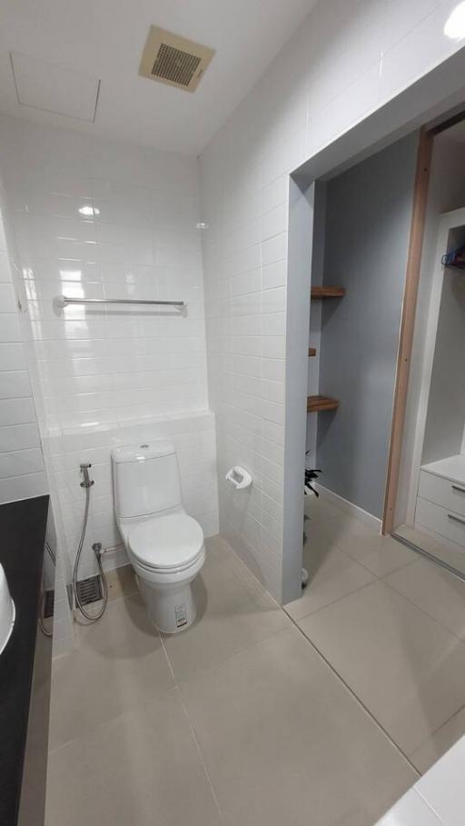 Modern bathroom with white tiles and elegant fixtures