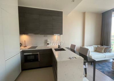 Modern kitchen with integrated appliances and adjacent living area