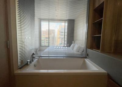 Modern bathroom with window view and built-in bathtub