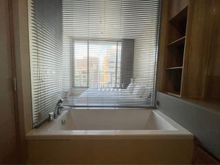 Modern bathroom with window view and built-in bathtub