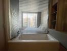 Modern bathroom with window view and built-in bathtub