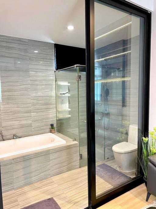 Modern bathroom with glass shower and bathtub