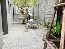 Paved outdoor seating area with greenery and modern design