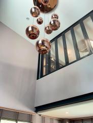 Modern interior with copper pendant lights and a second-story window