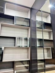 Modern shelving unit with reflective surfaces in an apartment