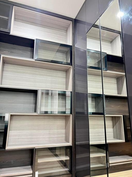 Modern shelving unit with reflective surfaces in an apartment