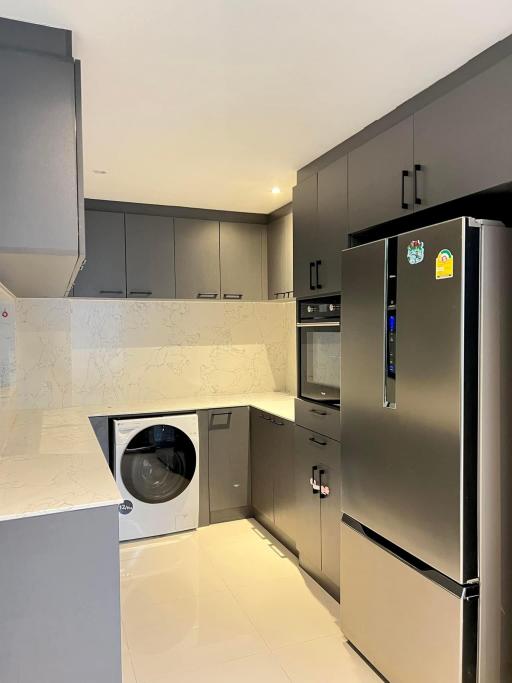 Modern kitchen with stainless steel appliances and built-in cabinetry