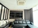 Modern living room interior with large comfortable couch, entertainment unit, and stylish decor