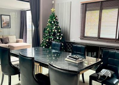 Elegant dining room with a Christmas tree and modern furnishings