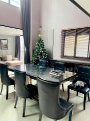 Elegant dining room with a Christmas tree and modern furnishings