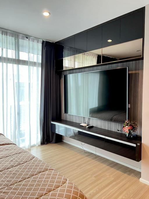 Modern bedroom interior with mounted television