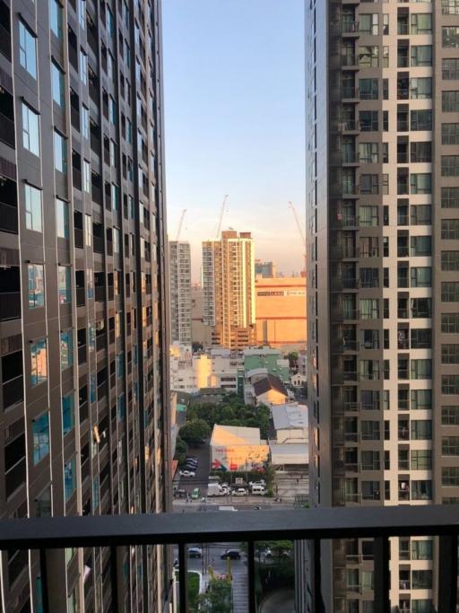 City view from a high-rise apartment balcony at dusk