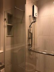 Modern bathroom with glass shower enclosure and wall-mounted shower system