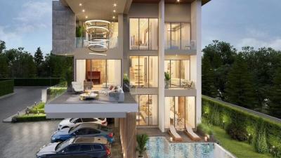 Modern multi-level building with exterior living space, pool, and garage