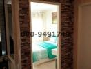 Cozy bedroom interior with decorative stone wall and mirror entrance