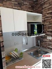 Modern kitchen with brick wall accent and white cabinetry