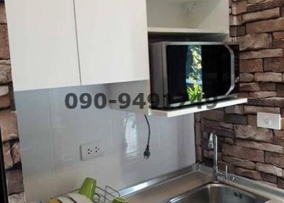 Modern kitchen with white cabinets and stainless steel sink