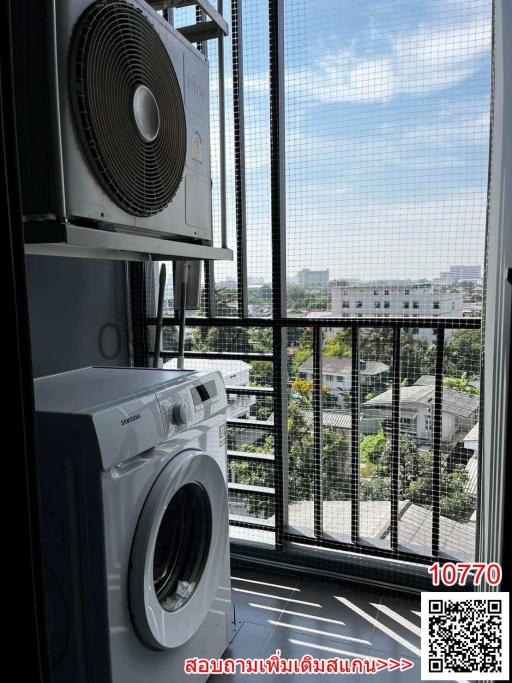 Modern laundry appliances by a window with a view
