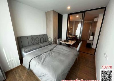 Modern bedroom with large bed and mirrored wardrobe leading to en-suite bathroom