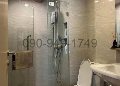Modern bathroom with glass shower enclosure and mounted water heater