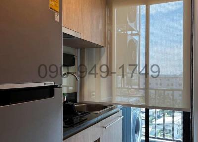 Modern kitchen with stainless steel appliances and ample natural light