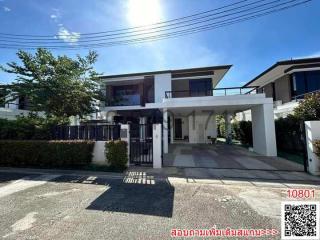 Modern two-story house with balcony and driveway