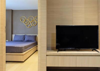 Modern bedroom with a large flat-screen TV