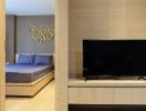 Modern bedroom with a large flat-screen TV