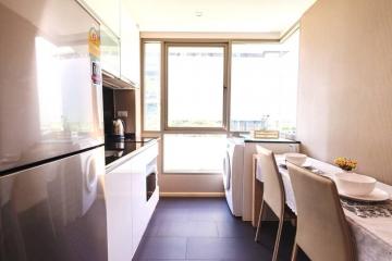 Modern kitchen with dining area and large windows