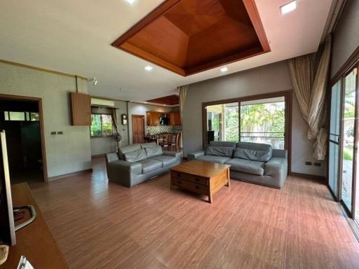 Spacious living room with high ceiling and abundant natural light