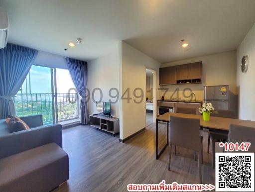 Spacious living room with modern furniture and balcony access