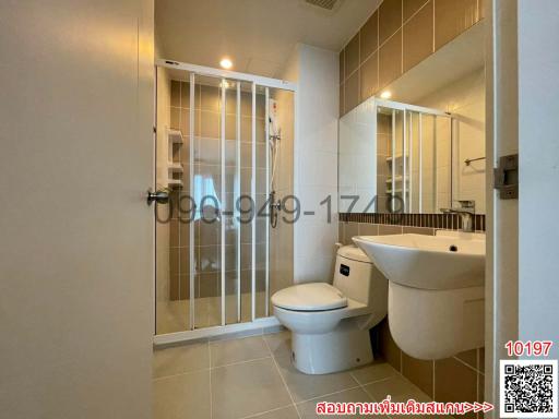 Modern bathroom interior with white fixtures and glass shower partition