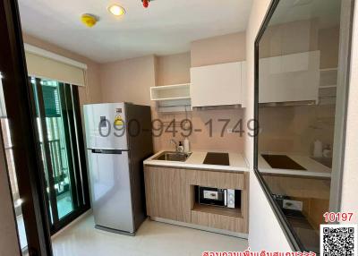 Compact modern kitchen with appliances and natural lighting