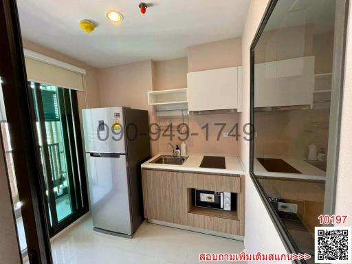 Compact modern kitchen with appliances and natural lighting