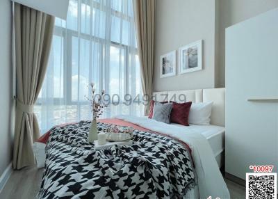 Bright Bedroom with Large Window and City View