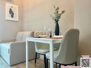 Modern dining area with seating for four adjacent to a living room