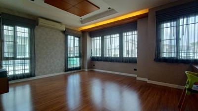 Spacious living room with large windows and hardwood floors