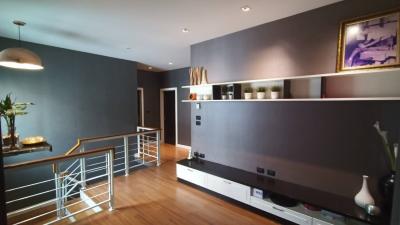 Modern living room with open shelving and hardwood floors