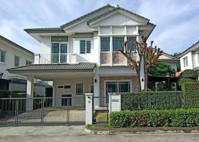 Modern two-story house with gated entry and landscaped front yard