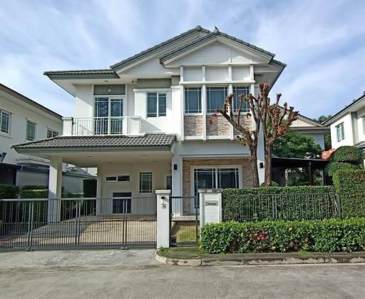 Modern two-story house with gated entry and landscaped front yard