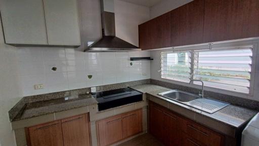 Modern kitchen with stainless steel appliances and wooden cabinets