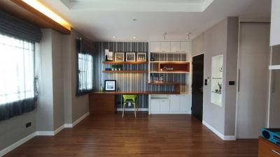 Modern living room with open shelving and dedicated workspace